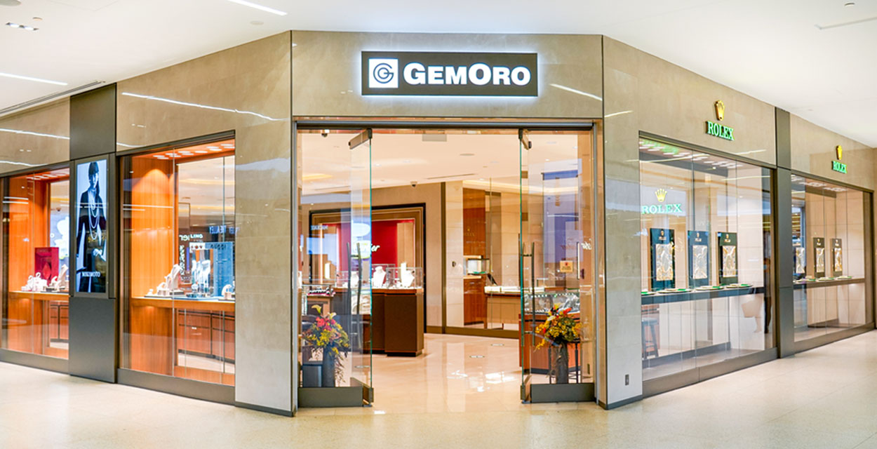 A storefront with a welcoming open door and Gemoro's logo mounted at the top.