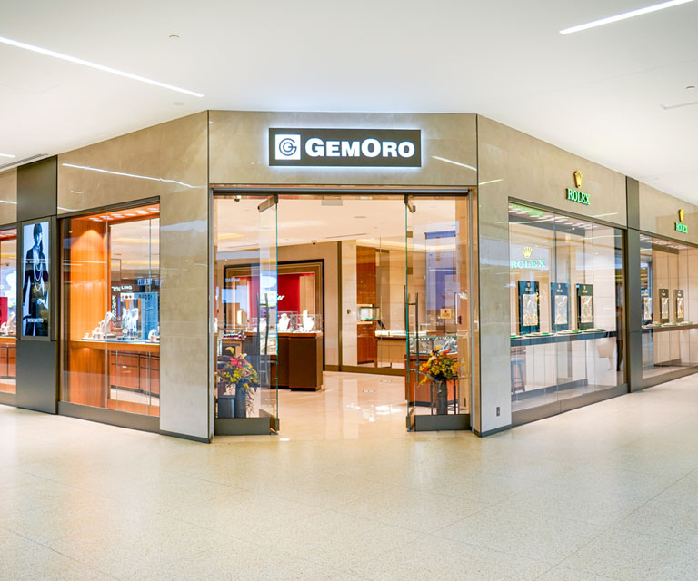 A storefront with a welcoming open door and Gemoro's logo mounted at the top.